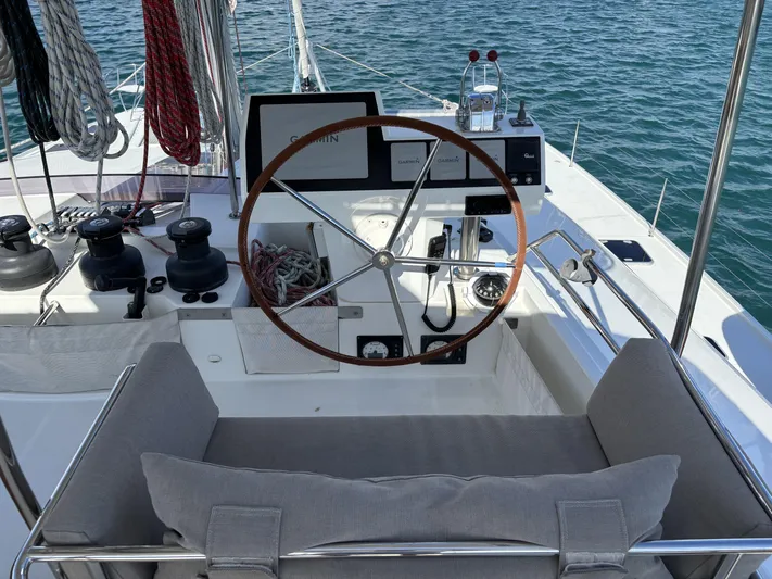 Adventure For Seven Yacht Photos Pics 2017 Fountaine Pajot Ipanema 58 yacht helm with wooden wheel and navigation equipment.