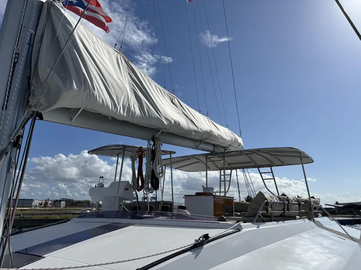 Adventure For Seven Yacht Photos Pics 2017 Fountaine Pajot Ipanema 58 catamaran with sails, docked under a clear blue sky.