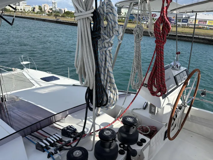 Adventure For Seven Yacht Photos Pics 2017 Fountaine Pajot Ipanema 58 yacht deck with ropes and steering wheel.