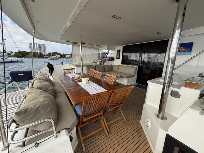 Adventure For Seven Yacht Photos Pics Luxurious 2017 Fountaine Pajot Ipanema 58 yacht with spacious outdoor seating and dining area.