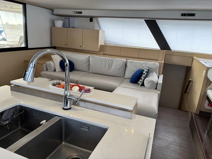 Adventure For Seven Yacht Photos Pics Luxurious interior of 2017 Fountaine Pajot Ipanema 58 catamaran with modern kitchen and seating area.