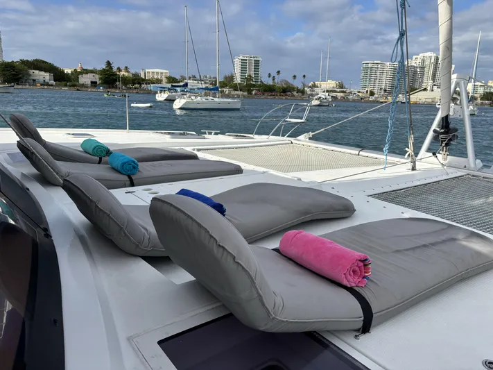 Adventure For Seven Yacht Photos Pics Luxurious 2017 Fountaine Pajot Ipanema 58 catamaran with sun loungers and vibrant towels on deck.