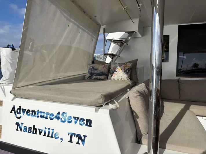 Adventure For Seven Yacht Photos Pics 2017 Fountaine Pajot Ipanema 58 catamaran with cushioned seating, labeled "Adventure4Seven," Nashville, TN.