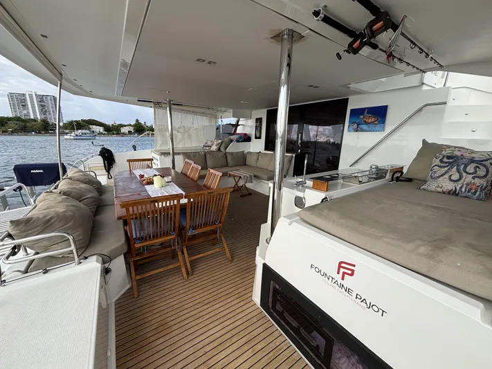 Adventure For Seven Yacht Photos Pics Luxurious 2017 Fountaine Pajot Ipanema 58 yacht with spacious outdoor seating and dining area.