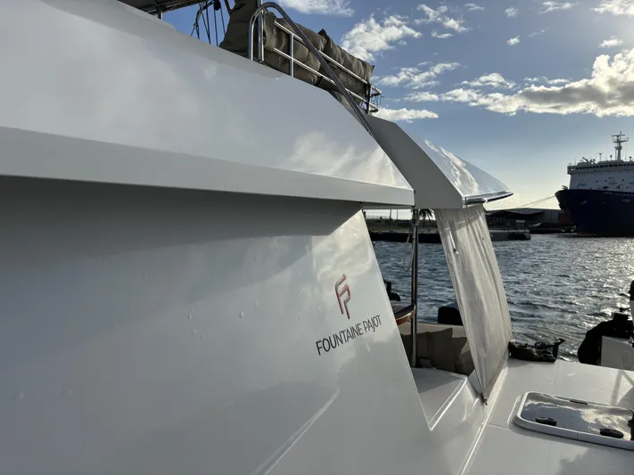 Adventure For Seven Yacht Photos Pics 2017 Fountaine Pajot Ipanema 58 catamaran docked, showcasing sleek design and branding.