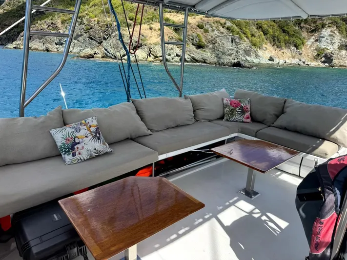 Adventure For Seven Yacht Photos Pics Luxurious seating area on 2017 Fountaine Pajot Ipanema 58 yacht, overlooking serene blue waters.