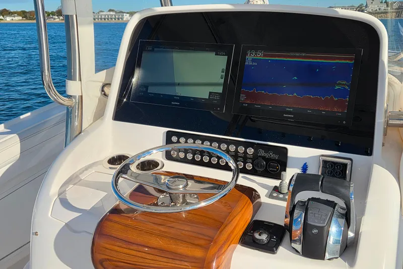 Sugar Mags Yacht Photos Pics 2022 Mag Bay 33 CC boat dashboard with navigation screens and controls.