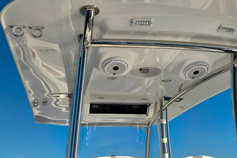 Sugar Mags Yacht Photos Pics 2022 Mag Bay 33 CC boat's T-top with speakers and lights against blue sky.