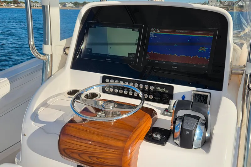 Sugar Mags Yacht Photos Pics 2022 Mag Bay 33 CC boat dashboard with navigation screens and controls.