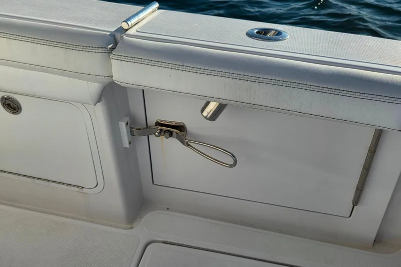 Sugar Mags Yacht Photos Pics 2022 Mag Bay 33 CC boat interior detail with white seating and storage compartment.