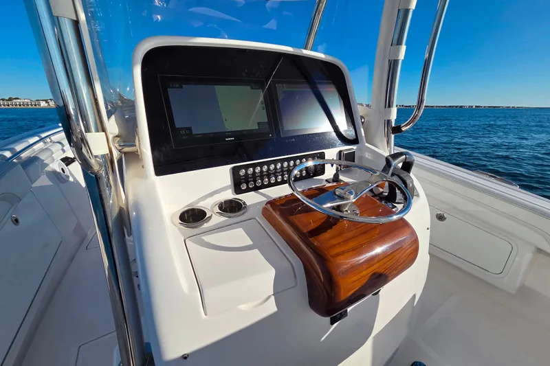 Sugar Mags Yacht Photos Pics 2022 Mag Bay 33 CC boat helm with modern controls and ocean view.