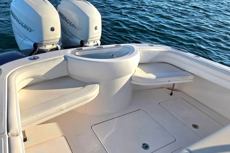 Sugar Mags Yacht Photos Pics 2022 Mag Bay 33 CC boat interior with twin Mercury engines, featuring white seating and storage.