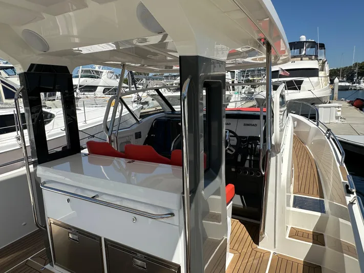 Mdr Yacht Photos Pics Nimbus T11 2021 model boat interior at marina, featuring helm and seating area.