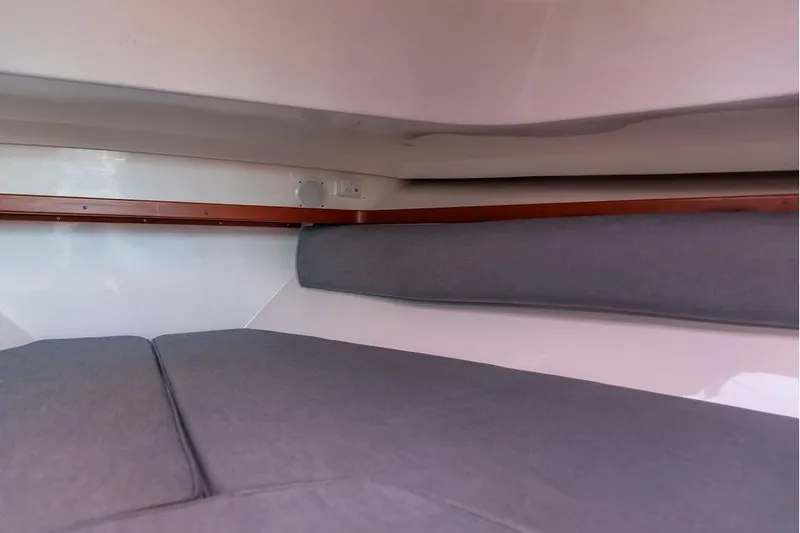 Battendown Yacht Photos Pics Interior cabin of 2007 Hunt Surfhunter 29 with gray cushions and wooden trim.