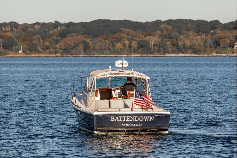 Battendown Yacht Photos Pics 2007 Hunt Surfhunter 29 boat on water, American flag, scenic background.