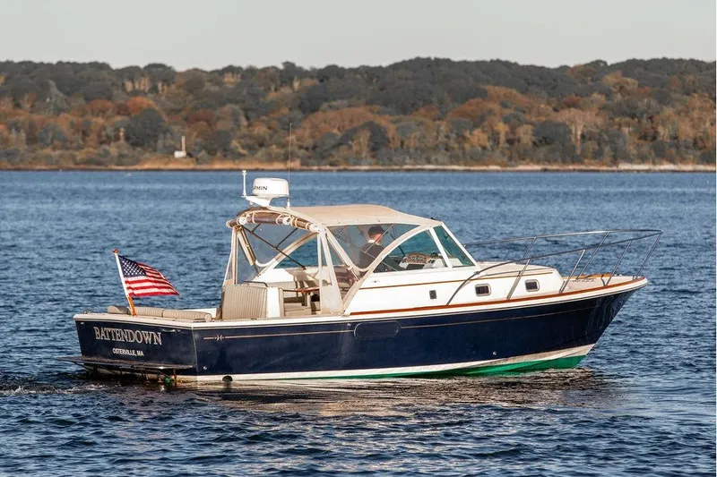 Battendown Yacht Photos Pics 2007 Hunt Surfhunter 29 boat cruising on a calm lake with forested shoreline.