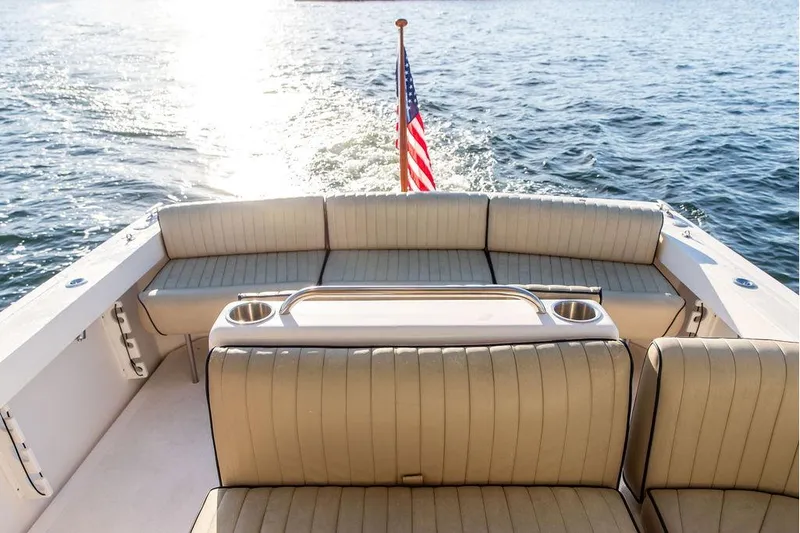 Battendown Yacht Photos Pics 2007 Hunt Surfhunter 29 boat interior with seating, American flag, and ocean view.