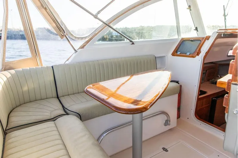Battendown Yacht Photos Pics Interior of 2007 Hunt Surfhunter 29 boat with seating and wooden table.