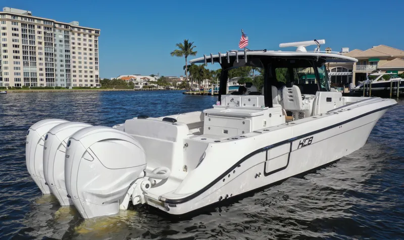  Yacht Photos Pics 2022 HCB 42 Lujo boat with triple engines on a sunny waterfront.