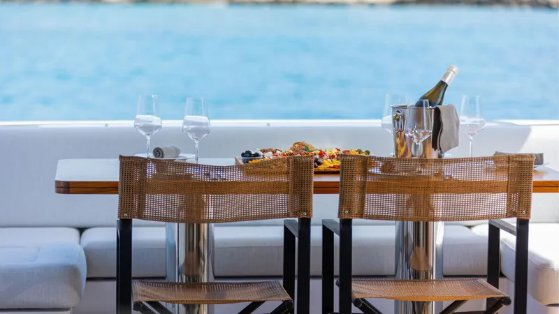 Genesis Yacht Photos Pics Outdoor dining setup on 2023 Azimut Fly 60 yacht with ocean view.