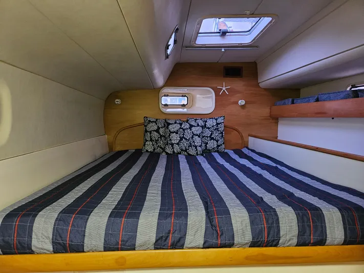Sandy Pause Yacht Photos Pics Cabin of a Leopard 47 yacht with striped bedding.