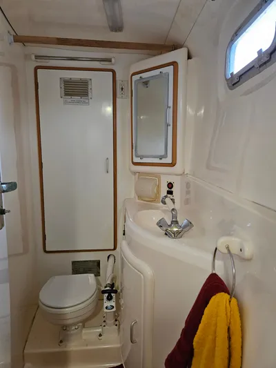 Sandy Pause Yacht Photos Pics Bathroom of a 2003 Leopard 47 yacht with toilet and sink.