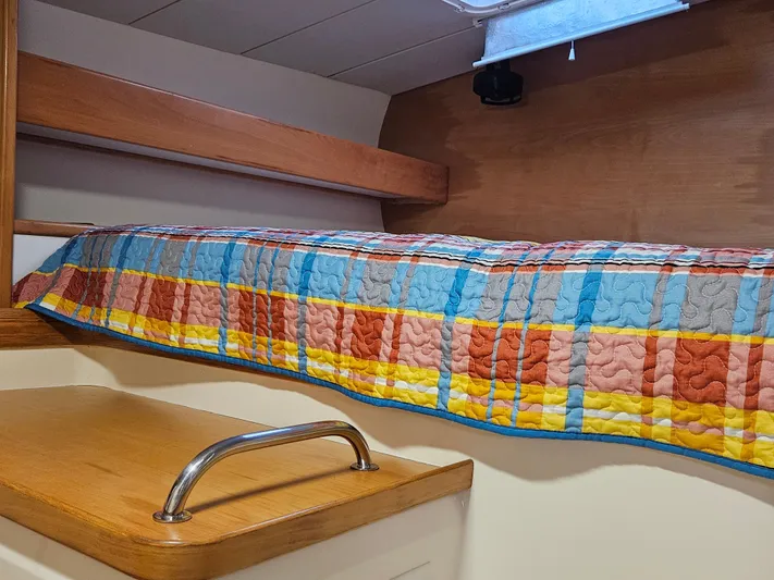 Sandy Pause Yacht Photos Pics Interior of a 2003 Leopard 47 yacht with colorful quilt.
