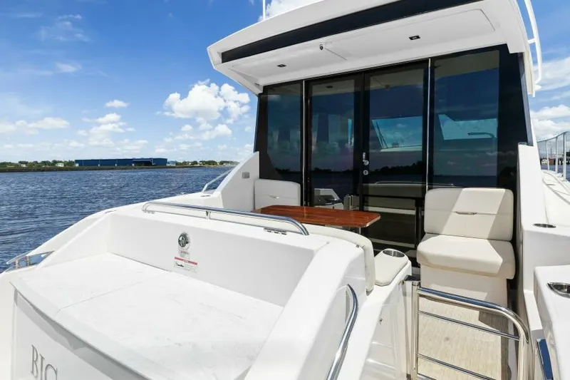 Big Eyes Yacht Photos Pics 2019 Tiara Yachts 39 Coupe, spacious deck with seating, docked by the water.