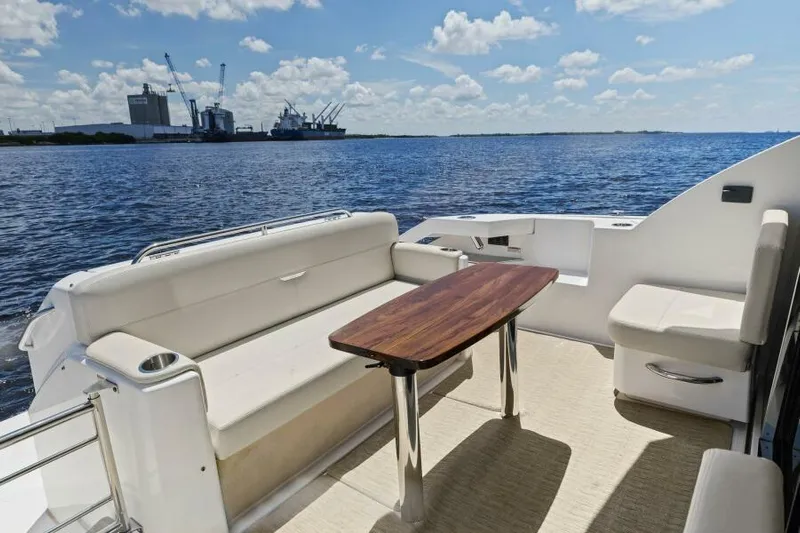 Big Eyes Yacht Photos Pics 2019 Tiara Yachts 39 Coupe deck with seating and table, overlooking serene waters.