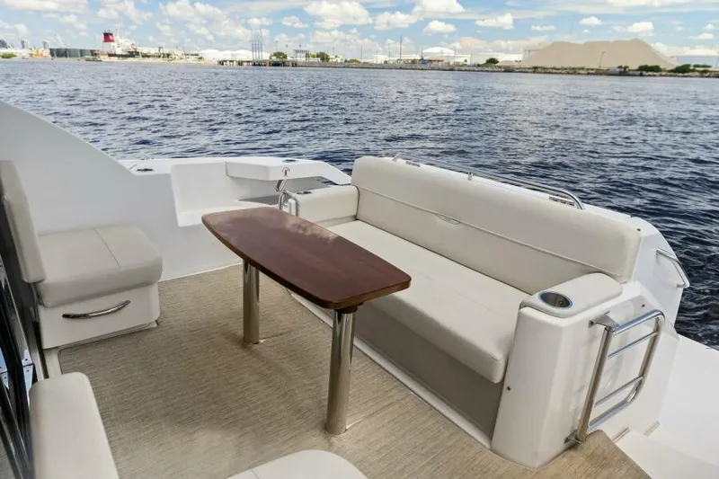 Big Eyes Yacht Photos Pics 2019 Tiara Yachts 39 Coupe deck with seating and table, overlooking calm waters.