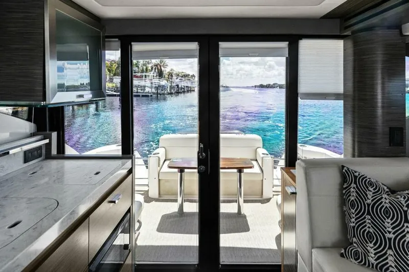 Big Eyes Yacht Photos Pics Interior view of 2019 Tiara Yachts 39 Coupe, featuring luxurious seating and scenic water view.