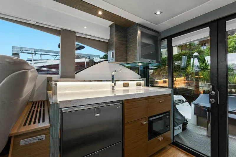 Big Eyes Yacht Photos Pics Luxurious interior of 2019 Tiara Yachts 39 Coupe with modern kitchen amenities.