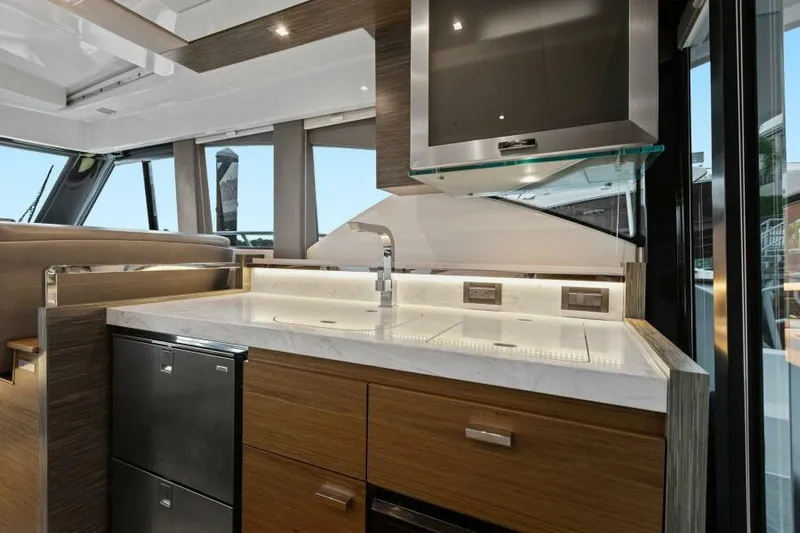 Big Eyes Yacht Photos Pics Modern kitchen interior of 2019 Tiara Yachts 39 Coupe with sleek countertops and cabinetry.