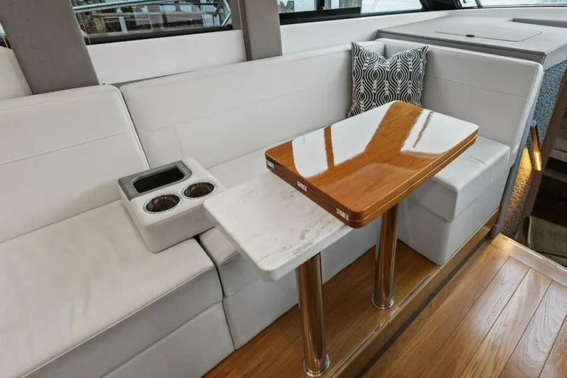 Big Eyes Yacht Photos Pics Luxurious interior of 2019 Tiara Yachts 39 Coupe with elegant seating and table.