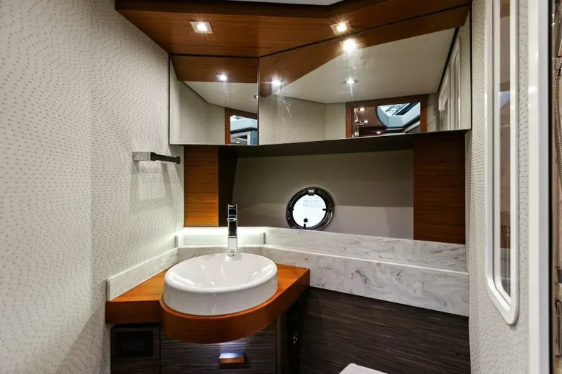 Big Eyes Yacht Photos Pics Luxurious bathroom interior of 2019 Tiara Yachts 39 Coupe with modern fixtures.