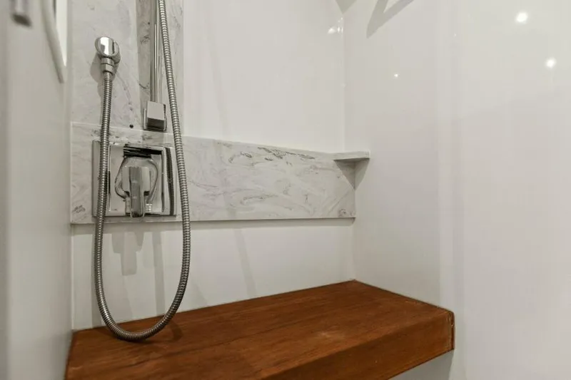 Big Eyes Yacht Photos Pics Shower area in 2019 Tiara Yachts 39 Coupe with wooden bench and modern fixtures.