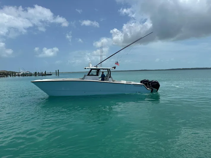  Yacht Photos Pics 2025 Freeman 38 boat on turquoise water under a partly cloudy sky.
