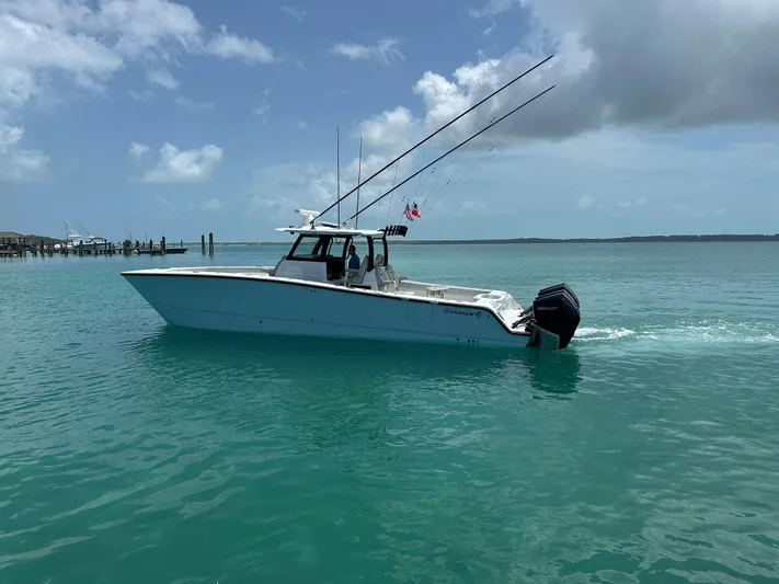  Yacht Photos Pics 2025 Freeman 38 boat cruising on turquoise water under a partly cloudy sky.