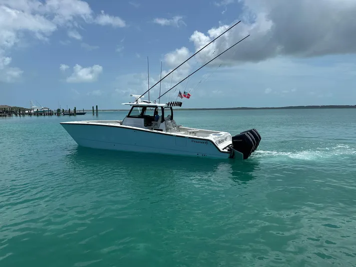  Yacht Photos Pics 2025 Freeman 38 boat cruising on turquoise water under a partly cloudy sky.