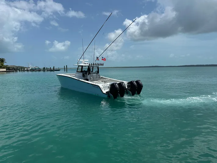  Yacht Photos Pics A 2025 Freeman 38 boat cruising on clear turquoise waters under a partly cloudy sky.