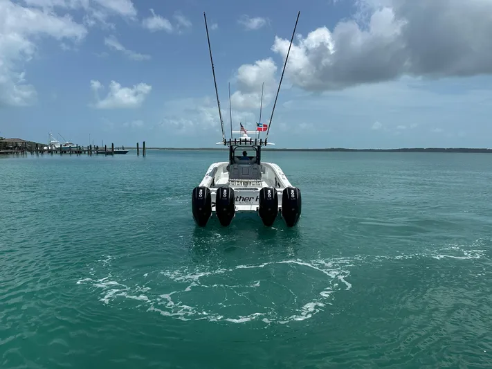  Yacht Photos Pics Freeman 38 boat on turquoise water, 2025 model, with four engines and clear sky.