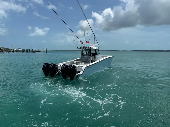  Yacht Photos Pics 2025 Freeman 38 boat cruising on turquoise waters under a partly cloudy sky.