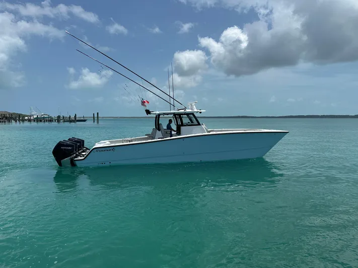  Yacht Photos Pics 2025 Freeman 38 boat on turquoise water under a partly cloudy sky.