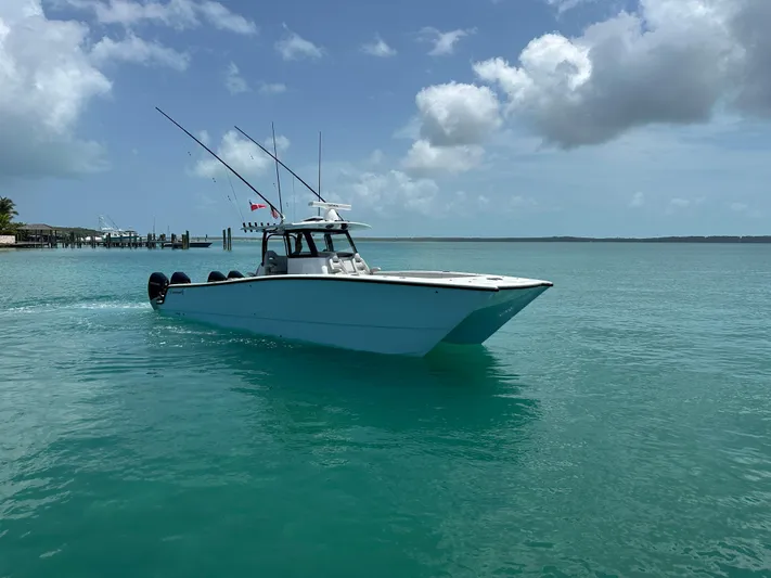  Yacht Photos Pics 2025 Freeman 38 boat cruising on clear turquoise water under a partly cloudy sky.
