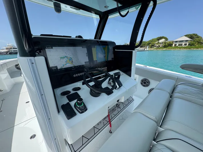  Yacht Photos Pics Modern Freeman 38 boat cockpit with advanced navigation system, steering wheel, and luxurious seating, 2025 model.