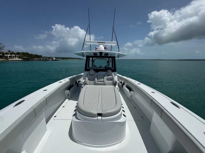  Yacht Photos Pics 2025 Freeman 38 boat on calm water under a partly cloudy sky.
