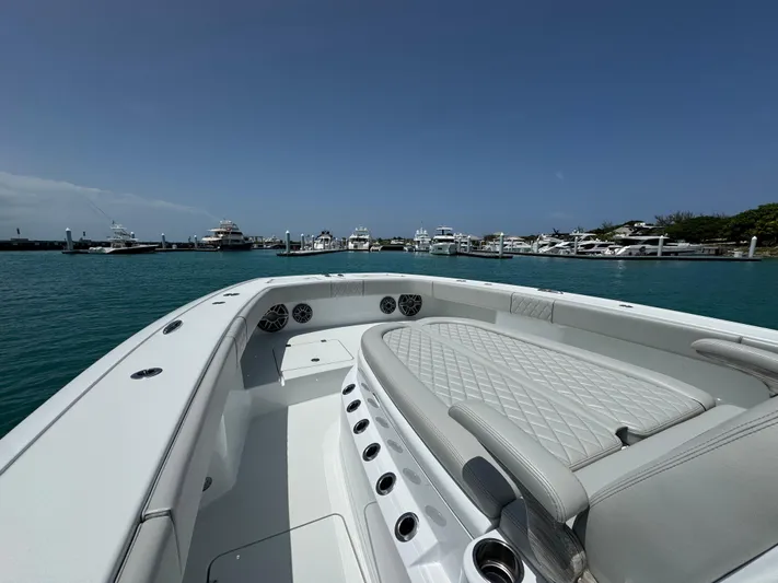 Yacht Photos Pics 2025 Freeman 38 boat with luxurious seating, docked in a marina under clear blue skies.