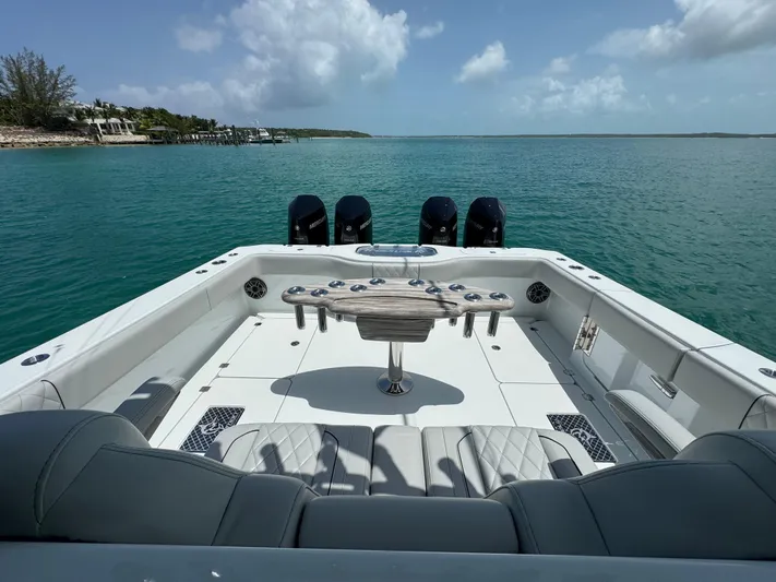  Yacht Photos Pics Freeman 38 boat, 2025 model, with spacious deck and multiple outboard motors on calm water.