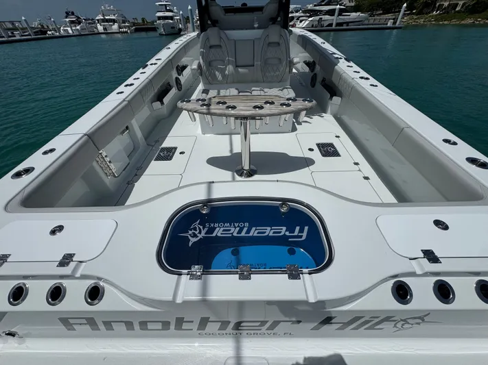  Yacht Photos Pics 2025 Freeman 38 boat interior with seating and fishing setup, docked in a marina.