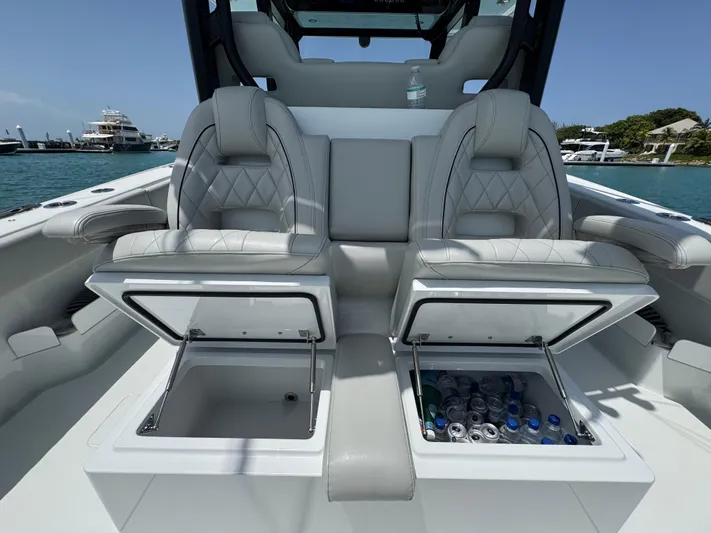  Yacht Photos Pics Luxury seating with storage on a 2025 Freeman 38 boat, featuring built-in coolers.